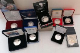 An assortment of cased silver crowns relating to QE2 to include: 1977 Silver Jubilee; 60th