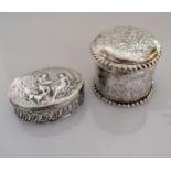 Two Continental 19th century silver boxes with allegorical scenes in relief to lids and sides,