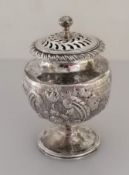 A George III silver pot-pourri holder of urn form with rococo and c-scroll decoration, pierced lid