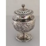 A George III silver pot-pourri holder of urn form with rococo and c-scroll decoration, pierced lid