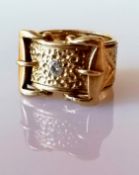 A large 9ct yellow gold buckle ring with brilliant-cut diamond, approximately 0.20 carats, size W,