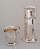 An Edwardian silver cylindrical vase with swag decoration in relief on a raised base by Roberts &