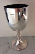 An Edwardian silver chalice or cup of plain form with beaded decoration and knop on a spreading foot