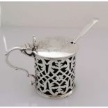 A Victorian silver mustard pot with etched lid, pierced cylindrical body, scroll handle, blue
