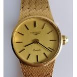 A 1980's ladies 9ct gold Longines quartz wristwatch, the circular gold tone dial signed 'Longines