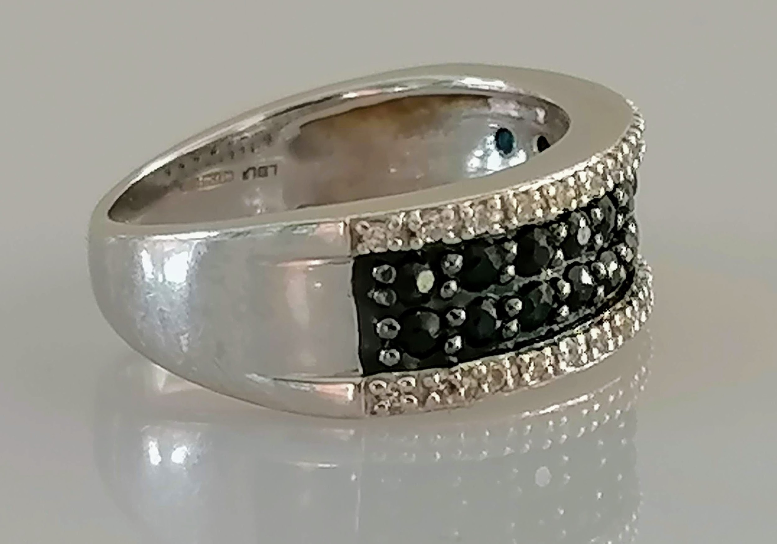 An 18ct white gold half-hoop eternity ring with pave-set white and black diamonds, size N1/2, - Image 2 of 4