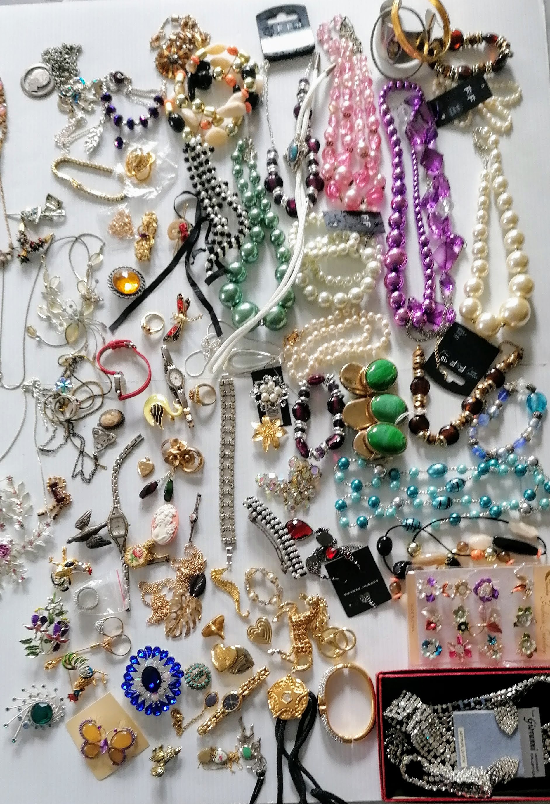 A large assortment of costume jewellery to include necklaces, brooches, rings, watches, etc.