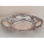 A George V silver oval table centre with C-scroll and repousse rococo decoration, Birmingham,