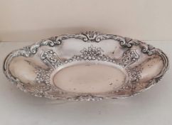 A George V silver oval table centre with C-scroll and repousse rococo decoration, Birmingham,