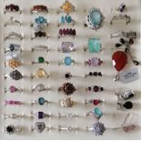 An assortment of forty silver -based gem-set rings, mostly sizes N-P, three pairs of earring and a