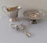 A Victorian silver tazza with pierced and embossed rococo design on a stepped foot by Haseler