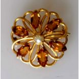 A circular citrine brooch in 9ct yellow gold centred with a pearl, 28mm diameter, hallmarked, 4.4g