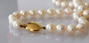 A mid-century necklet comprising fifty-four round/off-round cultured pearls, 7mm to 7.3mm