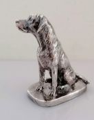 A silver model of a seated Labrador on an oblong base, signed Donaldson, 10.5 cm H, weighted,