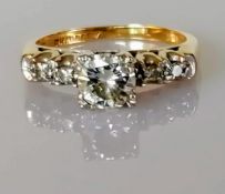 A five-stone gold and diamond ring, the central round brilliant-cut stone, 5.8 x 5.78 x 3.16mm,