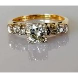 A five-stone gold and diamond ring, the central round brilliant-cut stone, 5.8 x 5.78 x 3.16mm,