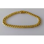 A yellow gold flat curb-link bracelet with box clasp, 29 cm, stamped 750, 23.65g