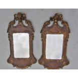 A near pair of Queen Anne period walnut and giltwood wall mirrors, Campana carved and scrolling