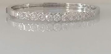 A diamond hinged bangle, set with thirteen round brilliant-cut diamonds weighing between 0.20-0.52