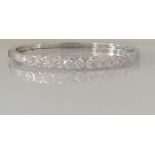 A diamond hinged bangle, set with thirteen round brilliant-cut diamonds weighing between 0.20-0.52