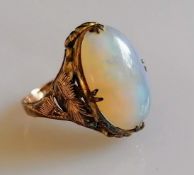 An oval opal ring on a gold claw setting, stamped 14k, size M, 3.2g, slight chip to opal (16mm x