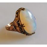 An oval opal ring on a gold claw setting, stamped 14k, size M, 3.2g, slight chip to opal (16mm x