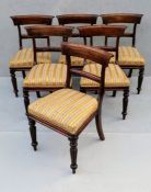 A set of six George IV mahogany-framed dining chairs with carved support, fabric upholstery, on flut