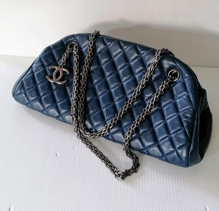 A Chanel Mademoiselle Bowling Bag in quilted blue leather with dual black chain straps and CC pendan