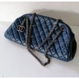 A Chanel Mademoiselle Bowling Bag in quilted blue leather with dual black chain straps and CC pendan