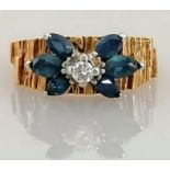 A mid-century gold, diamond and sapphire ring witt textured shank, size L, unmarked