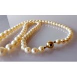 A mid-century single row of sixty-nine graduated Akoya cultured pearls measuring 6mm to 9.7mm