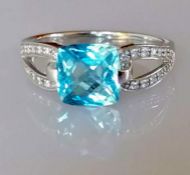 An white gold and diamond decorated topaz ring, cushion cut, approximately 7 x 9mm