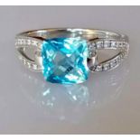 An white gold and diamond decorated topaz ring, cushion cut, approximately 7 x 9mm
