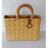 A Christian Dior Lady MM bag in yellow cannage quilted fabric with gold tone hardware, double top ha