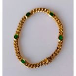 An 18ct yellow gold flat curb-link bracelet with oval emerald decoration, box clasp, 17.5 cm, stampe