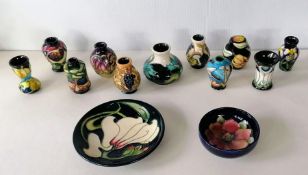 An assortment of eleven Moorcroft smaller vases, all in good condition without visible damage or rep