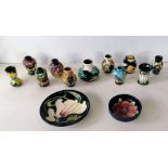 An assortment of eleven Moorcroft smaller vases, all in good condition without visible damage or rep