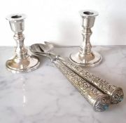 A pair of silver candlesticks on stepped bases, weighted, stamped 925, each 12 cm H