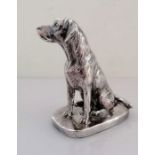 A silver model of a seated Labrador on an oblong base, signed Donaldson, 10.5 cm H,