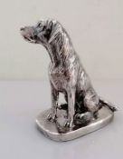 A silver model of a seated Labrador on an oblong base, signed Donaldson, 10.5 cm H, weighted