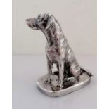 A silver model of a seated Labrador on an oblong base, signed Donaldson, 10.5 cm H, weighted