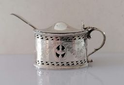 An Edwardian silver oval mustard pot with beaded borders, pierced body, bright-cut floral swags