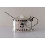 An Edwardian silver oval mustard pot with beaded borders, pierced body, bright-cut floral swags