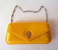 A Smythson yellow leather Mara clutch bag with detachable chain, silver tone fixtures, interior zip