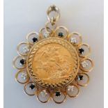 A mounted George V gold full sovereign pendant with sapphire and diamond decoration, dated 1915, hal