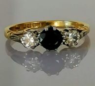 An 18ct yellow gold three-stone diamond and sapphire ring, the sapphire approximately 0.50 carats, t