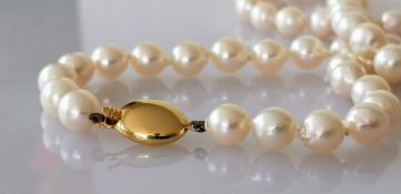 A mid-century necklet comprising fifty-four round/off-round cultured pearls, 7mm to 7.3mm diameter