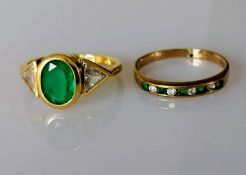 An emerald and diamond gold ring, the oval emerald approximately 8 x 6 mm