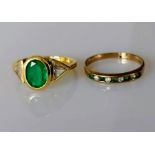 An emerald and diamond gold ring, the oval emerald approximately 8 x 6 mm