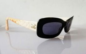 A pair of Chanel black-framed sunglasses with beige/pink quilted arms, original case, outer box and